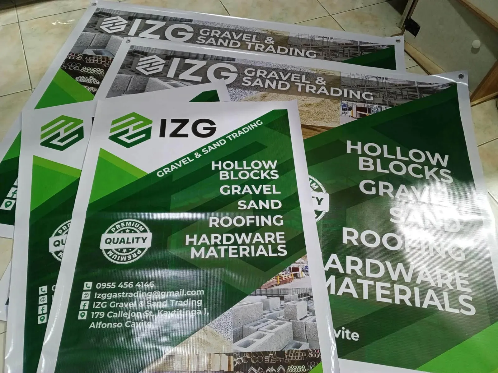 Several green business tarpaulins for a gravel and sand supplier