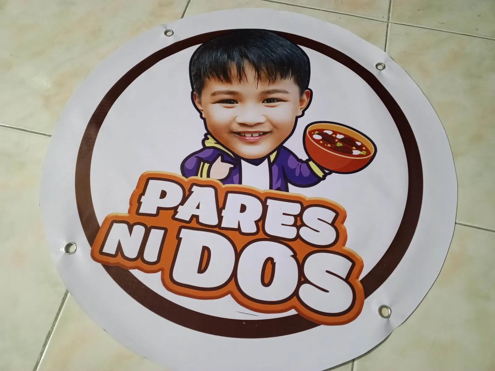 Round tarpaulin sign for a food stall, with grommets at the edge